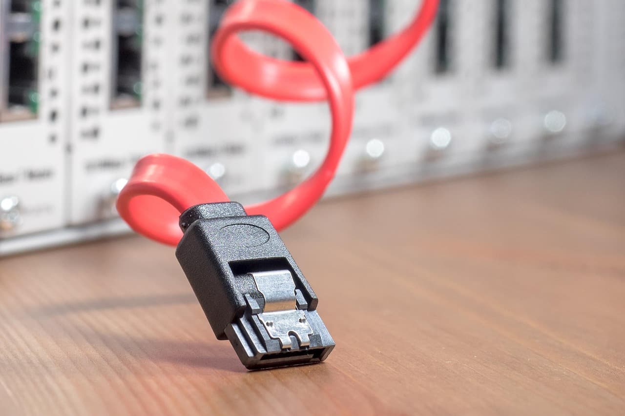 A red data cable and rack hardware